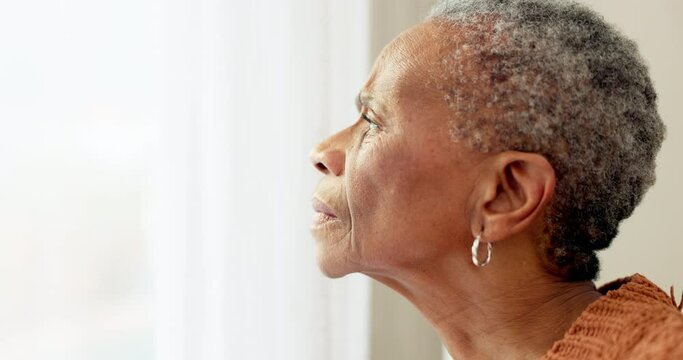 Senior woman, face and thinking by window at home to remember memory and relax in retirement. Serious black elderly person or old lady at nursing facility with hope, sad emotion and Alzheimer disease