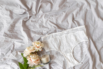 Obraz na płótnie Canvas Gentle white lace pants on the bed. Women tender briefs, lingerie, underwear. Top view, close up. Flat lay, beauty blog or social media minimal concept. Present for Valentines, Women’s day 