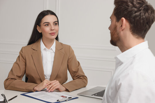 Human resources manager conducting job interview with applicant in office