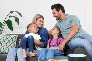 Obraz premium Happy family having fun together on sofa at home