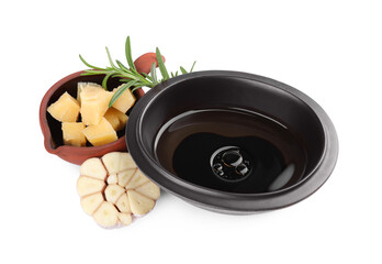 Bowl of balsamic vinegar with oil, parmesan cheese, rosemary and garlic on white background