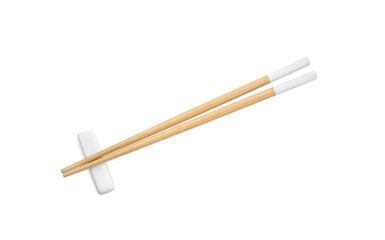 Pair of wooden chopsticks with rest isolated on white, top view