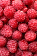 Heap of tasty ripe raspberries as background, top view
