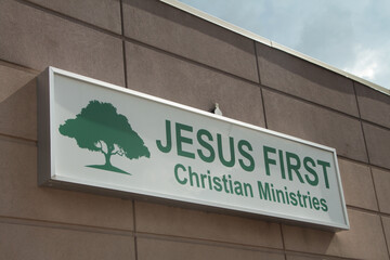 jesus first christian ministries rectangle sign in green writing on white background with picture...