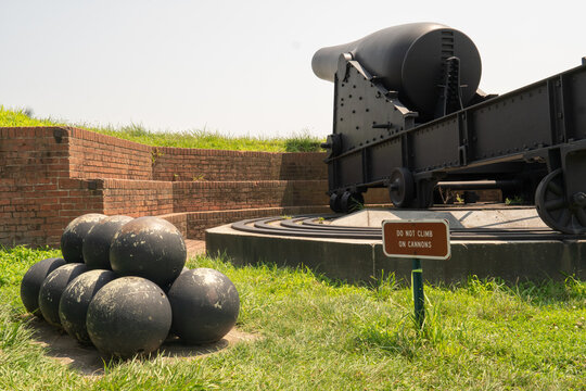 Baltimore, MD US - July 26, 2023: Round shot, or cannonballs stacked next to a canon facing the direction of the British Fleet on Sept 13, 1814 at Fort McHenry National Monument and Historic Shrine