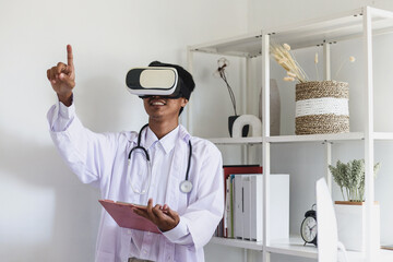 Young Asian man doctor wearing vr goggles headset watching and hand touching in modern office...