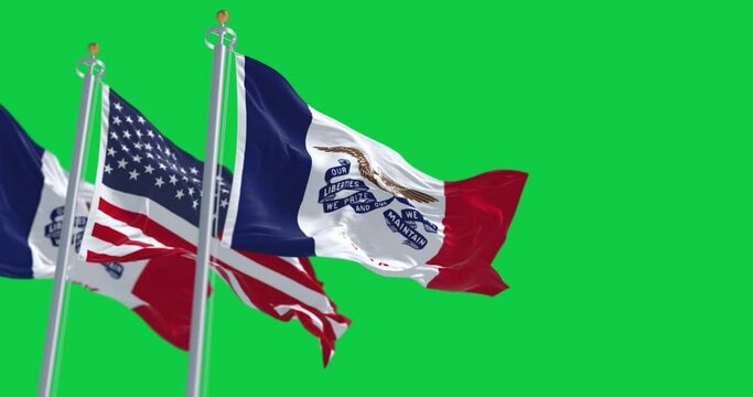Flags of Iowa and the United States waving isolated on a green background