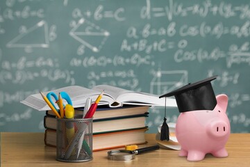 Student Success and education investment concept, piggy bank and books
