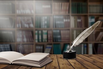 Old retro quill pen  and books on a desk