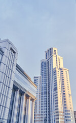 Obraz premium Skyscrapers, high-rise buildings from below against the sky, urban landscape, panorama of skyscrapers. Bottom view of modern skyscrapers in the business district. High quality photo