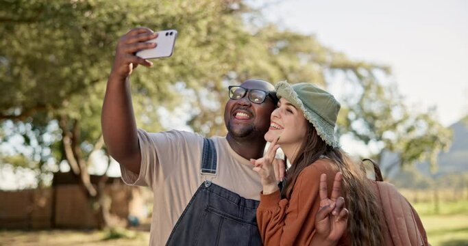 Interracial, couple and selfie, camping in nature with happiness and social media post with friends. Live streaming, peace hand sign and memory, black man and woman outdoor with smile in picture