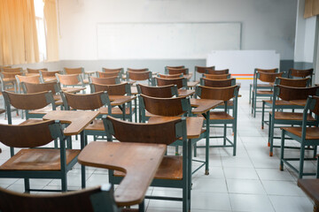 Fototapeta na wymiar Empty classroom with vintage tone wooden chairs. Back to school concept