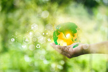 green energy concept. Global warming icons set on hands with nature green background. Net zero 2050...