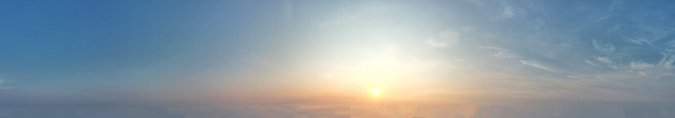 Graceful blue sky adorned with bright orange sunlight paints a breathtaking picture of nature's artistry.