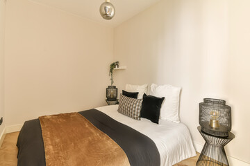 a bedroom with white walls and wood flooring the room is decorated in neutral tones, including...