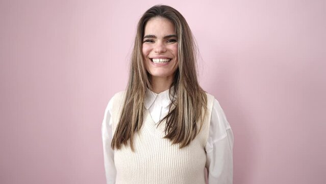 Young beautiful hispanic woman smiling confident over isolated pink background