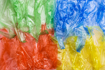 Colorful Plastic bags texture, top view crumpled plastic bag crumpled, vibrant colored textured background. Surface from Disposable polythene packet. Reusable materials, packaging waste