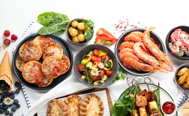 Family dinner or lunch. Many dishes on the table. Summer.