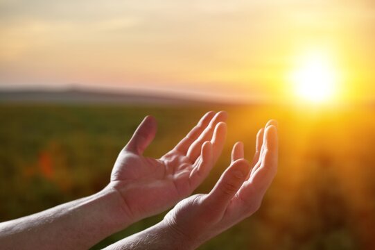 Human hands worship Praying on sky background
