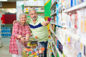 Indian senior couple shopping together at grocery shop.