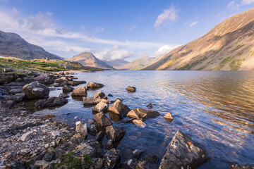 The vastness of Wastwater nestled in the Wasdale valley with scafell pike rising in the background,...