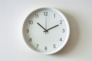 A simple clock hanging on a white wall