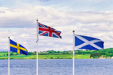 Swedish, Great Britain and the Scottish flag at the coast in Scotland