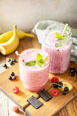 Raspberries, bananas and black currant. Set of fresh various delicious milkshakes or smoothies with fresh berries. Copy space.