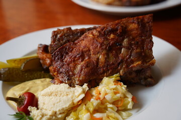 Ribs in spicy marinade with chili, honey, sour cabbage, pickle cucumber and mustard