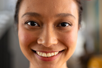 Portrait of happy asian woman with tied hair at home