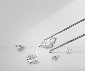 Shiny brilliant diamond in diamond tweezers, and round diamond with reflection