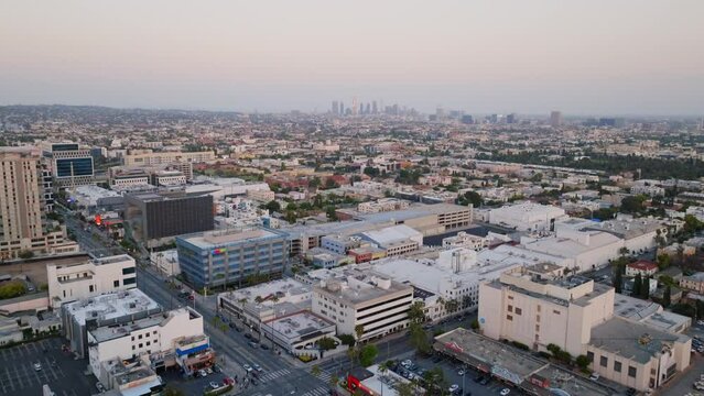 Drone flight over Hollywood Boulevard with up tilt toward Los Angeles skyline