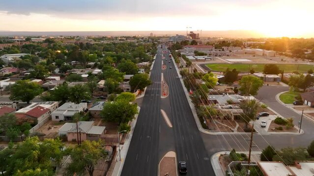 Bright sunset over housing suburb in Albuquerque, New Mexico. Adobe style houses and homes along main road near University of New Mexico.