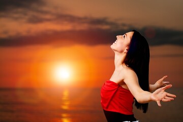 Young woman laughs looking to the sky,