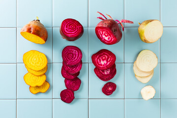 Sliced beets of different colors, white, yellow, purple. Top view.