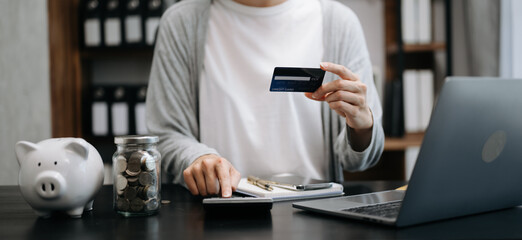 businesswoman hand using smart phone, tablet payments and holding credit card online shopping, omni channel, digital tablet docking keyboard computer at office in sun light.