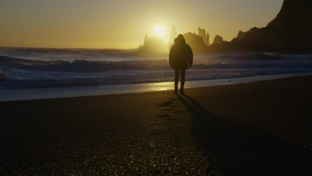 A Man Faces The Sunset On Reynisfjara Beach