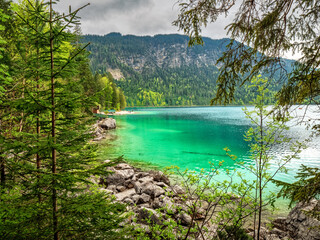 Fototapeta na wymiar View to the Bavarian Lake Frillensee lake during spring with pure turquoise and clear water