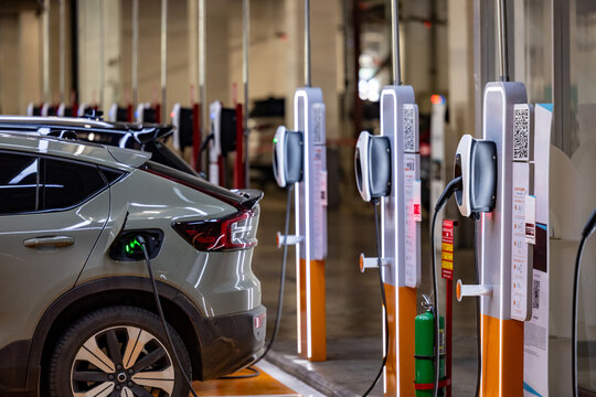 EV charging an electric car.Power supply for electric car charging. Socket for electric car battery charger. EV car charging station. Nature energy, Clean energy, Green eco concept. Plugging in cable.