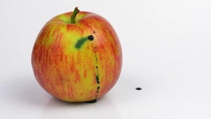 Poison Injected into Apple from Syringe by Person in Blue Gloves