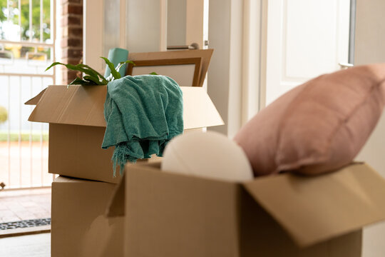 Close up of moving boxes on floor in hall at home