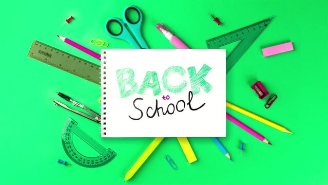 Back to school video stop motion animation. School supplies and appearing inscription.