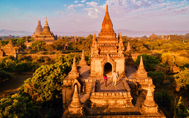 Bagan Myanmar, Sunrise above temples and pagodas of Bagan Myanmar, Sunrise Pagan Myanmar temple and pagoda. Men and woman at an old pagoda during a vacation in Myanmar, couple visit a temple in Bagan