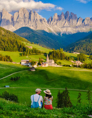 Couple viewing the landscape Italy dolomites Val di Funes in summer, Santa Magdalena village magical Dolomites mountains, Val di Funes valley, Trentino Alto Adige region, South Tyrol, Italy, - obrazy, fototapety, plakaty