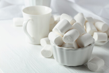 White marshmallows on a wooden table.