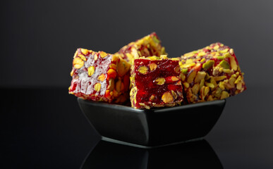Traditional Turkish delight in a small black dish.