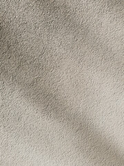 Shadows on a plastered beige wall. Abstract background, grunge concrete texture. Minimal vertical backdrop. - 628415482
