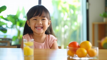 Obraz premium Happy smile kid at table in kitchen with healthy breakfast in morning.