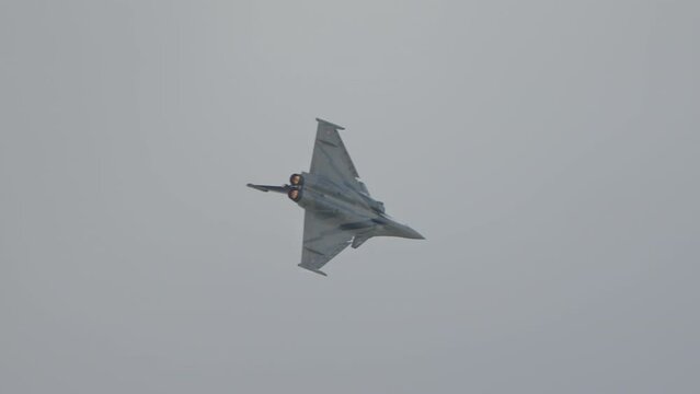 Advanced fighter jet performing high speed manoeuvres at low altitude