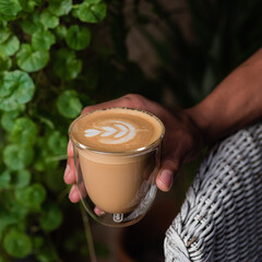 hand holding cup of coffee